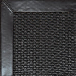 Close-up of woven leather rug with a wide leather binding in dark brown.