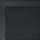 Close-up of woven leather rug with a wide leather binding in black.