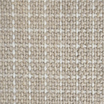 Close-up of a carpet with a textured check pattern in beige and cream. 