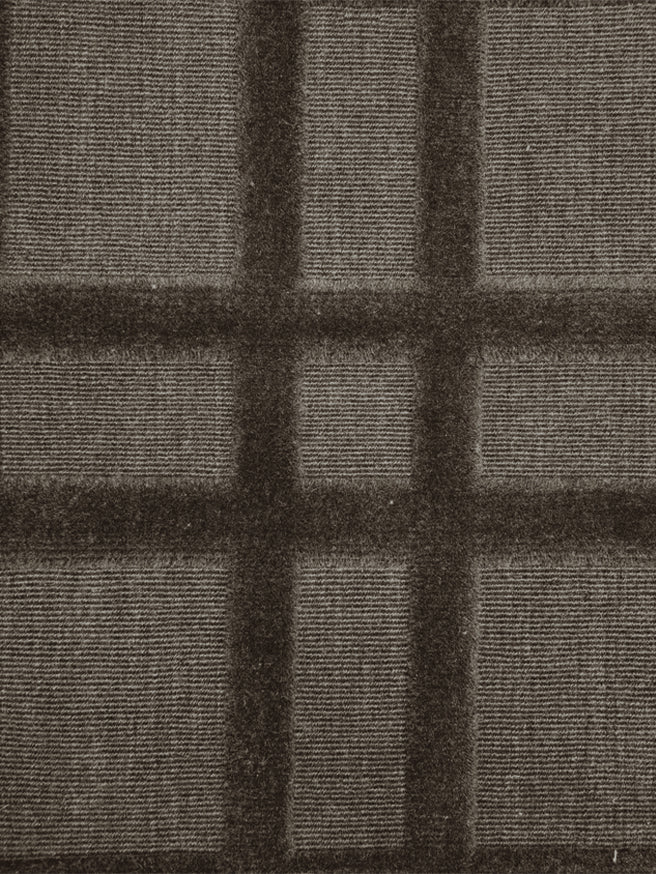 Broadloom carpet in a dimensional plaid pattern in brown.