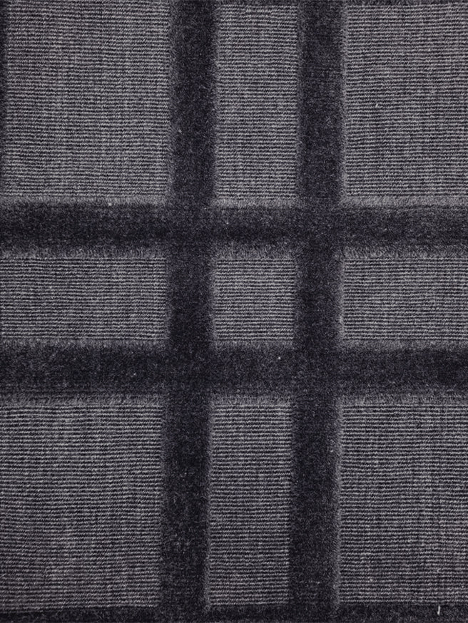 Broadloom carpet in a dimensional plaid pattern in navy blue.