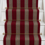 Striped brown flatweave runner in red on white stairs