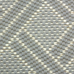 Broadloom carpet in a diamond lattice pattern in light blue and cream. 