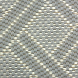 Broadloom carpet in a diamond lattice pattern in light blue and cream. 