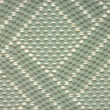 Broadloom carpet in a diamond lattice pattern in light green and cream. 