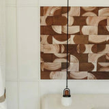 An inlaid panel over a headboard of leather wall tiles in a repeating curvolinear pattern in brown and tan.