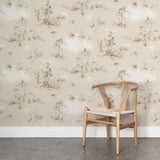 A wooden chair stands in front of a wall papered in a painterly bird and branch print in shades of brown, white and cream.