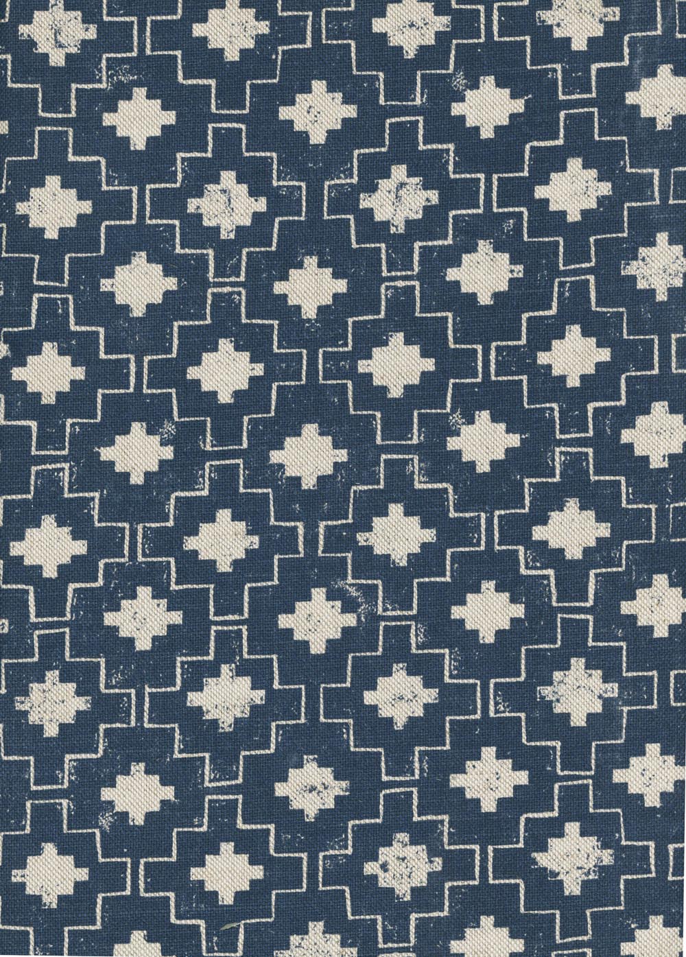 Detail of fabric in a geometric grid print in white on a navy field.