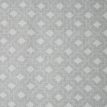 Detail of fabric in a geometric grid print in white on a gray field.