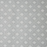 Detail of fabric in a geometric grid print in white on a gray field.