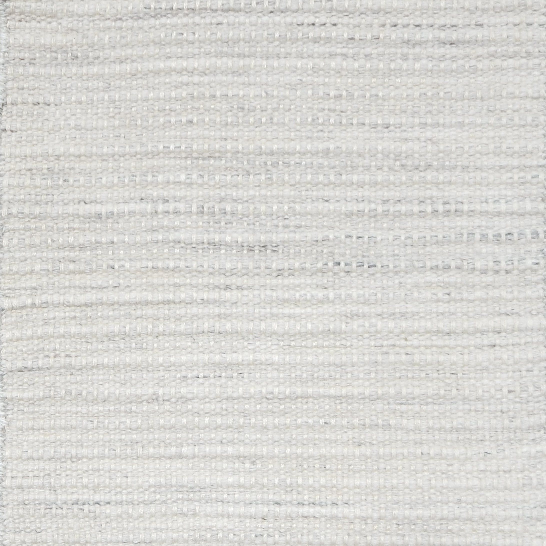 Close-up of white textured woven rug