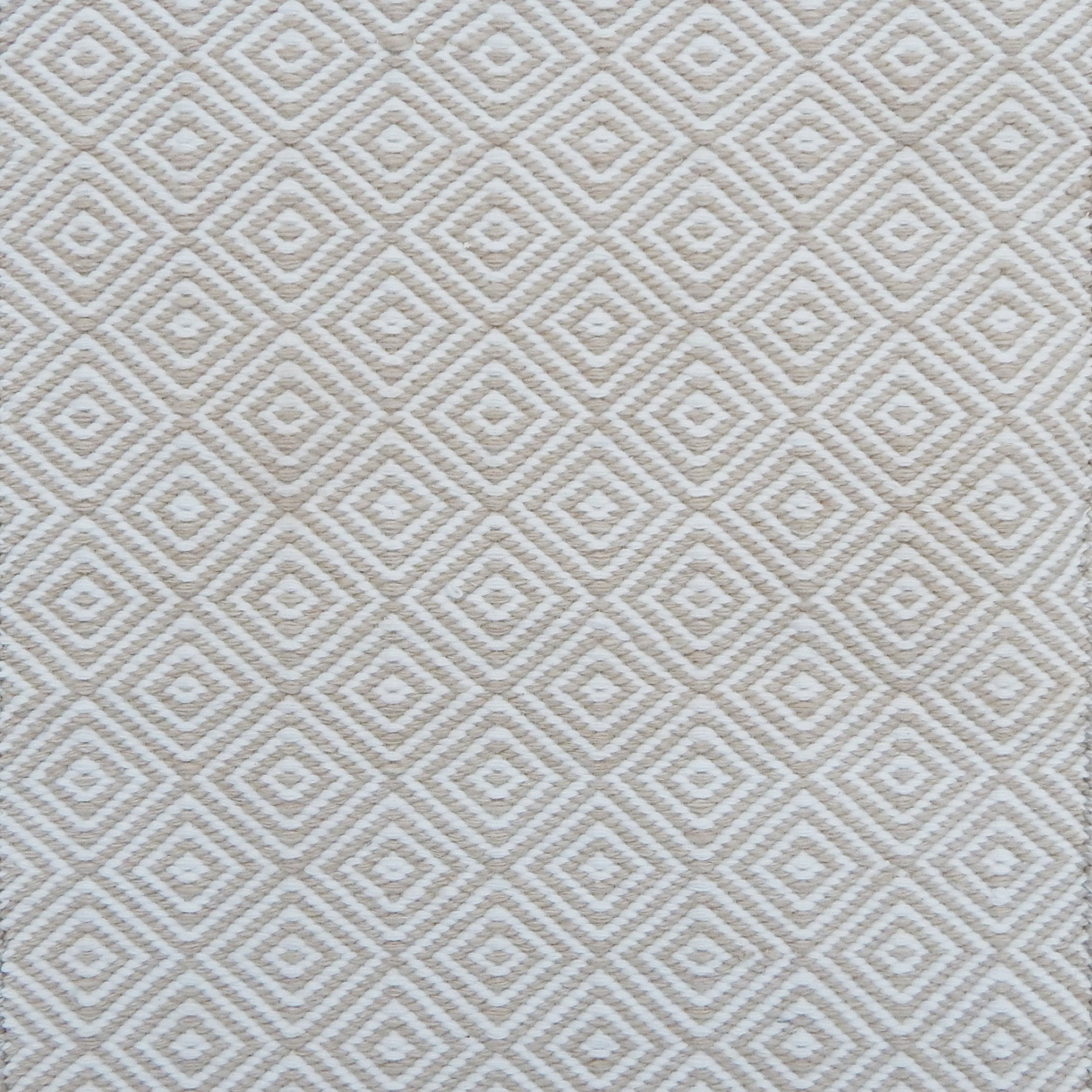 Patterned rug with a geometric diamond design in beige and cream