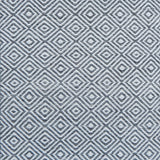 Patterned rug with a geometric diamond design in grey and white.