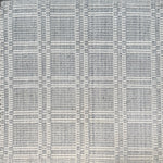 Woven rug in a plaid check in slate blue and white. 