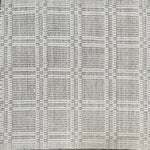 Woven rug in a plaid check in grey and white. 