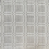 Woven rug in a plaid check in grey and white. 