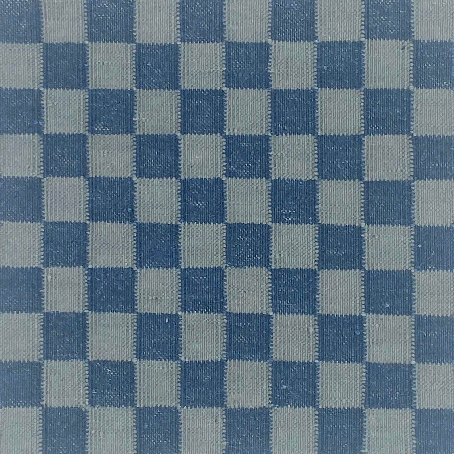 Checkered pattern carpet with alternating blue and gray squares