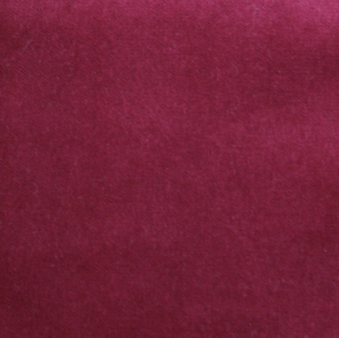 Detail of velvet fabric yardage in dark red.