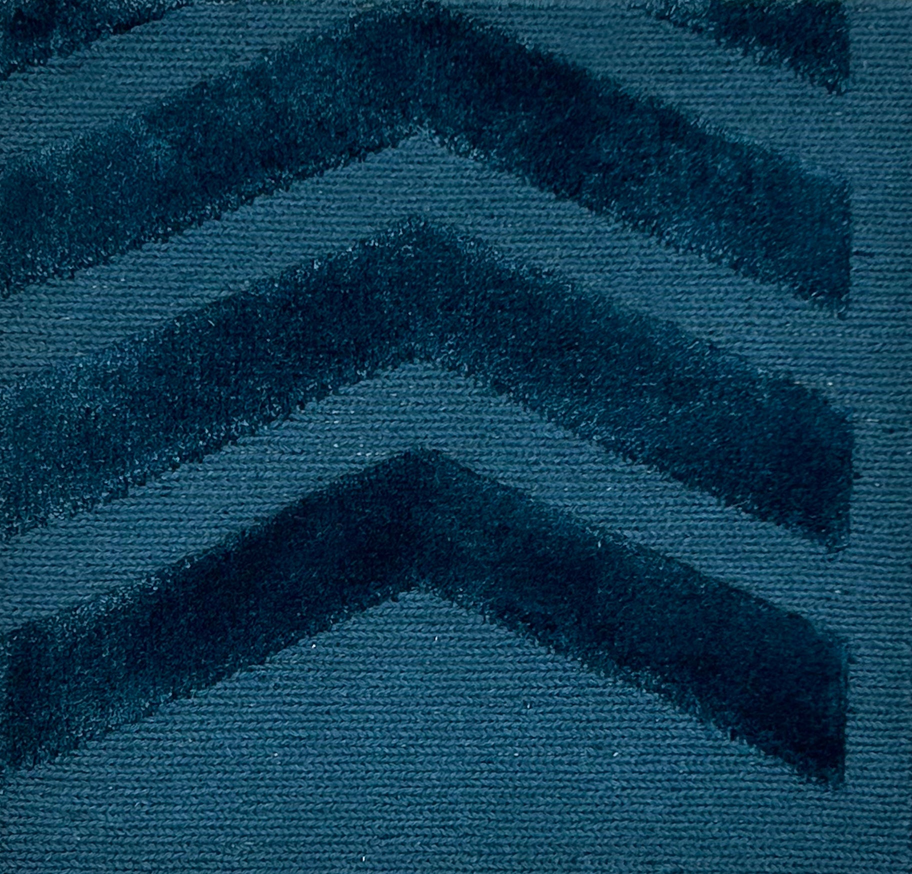 Teal blue rug with chevron pattern