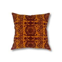 Square throw pillow in a repeating linear block print pattern in brown on a burnt orange field.
