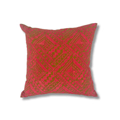 Square throw pillow in a repeating square block print pattern in hot pink on an olive field.