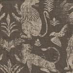 Close-up of fabric in a lion and plant print in cream on a mottled gray field.