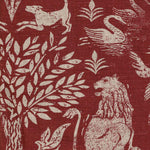 Close-up of fabric in a lion and plant print in white on a mottled red field.