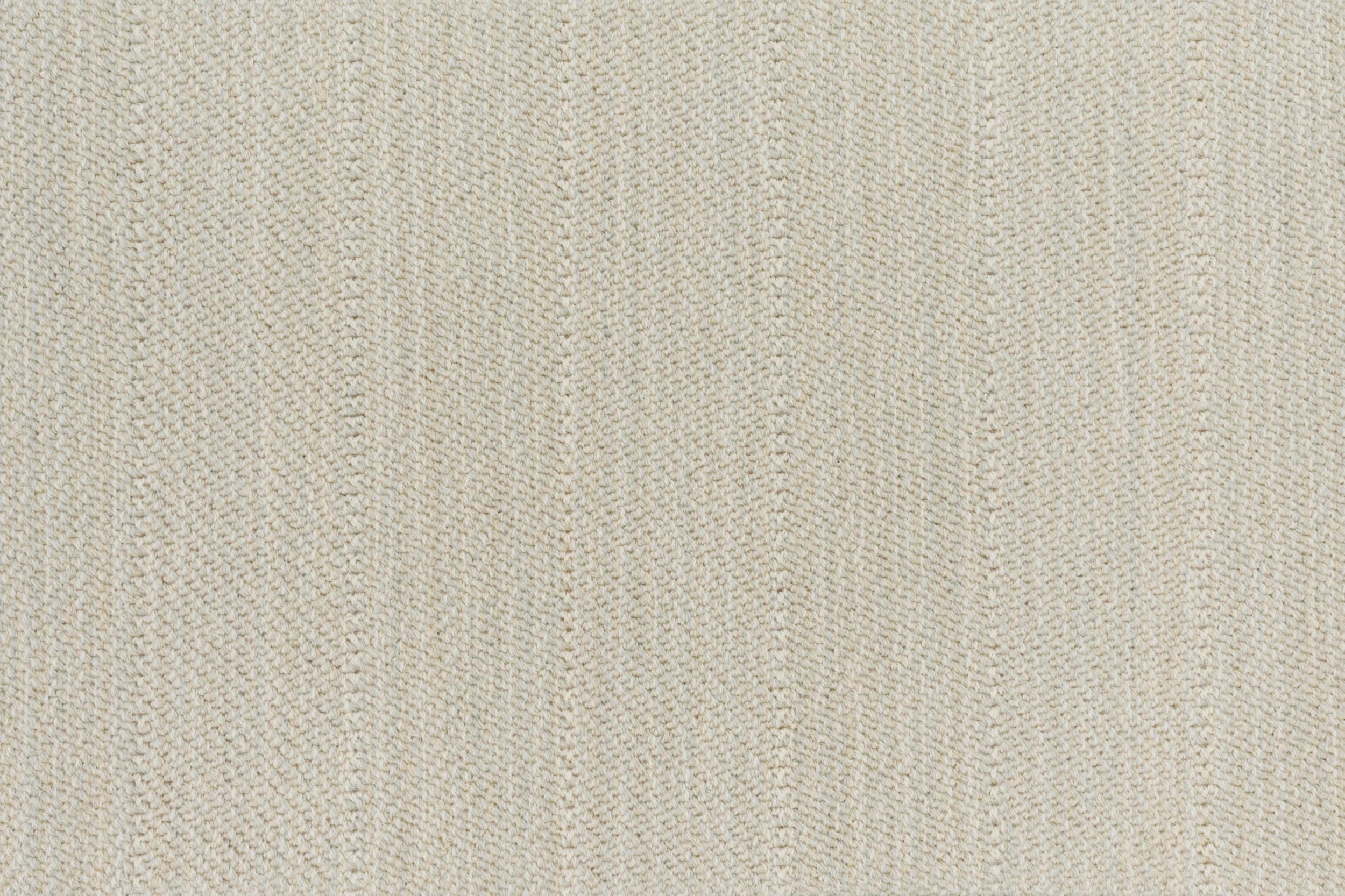Close up of a broadloom carpet with a herringbone stripe in cream.