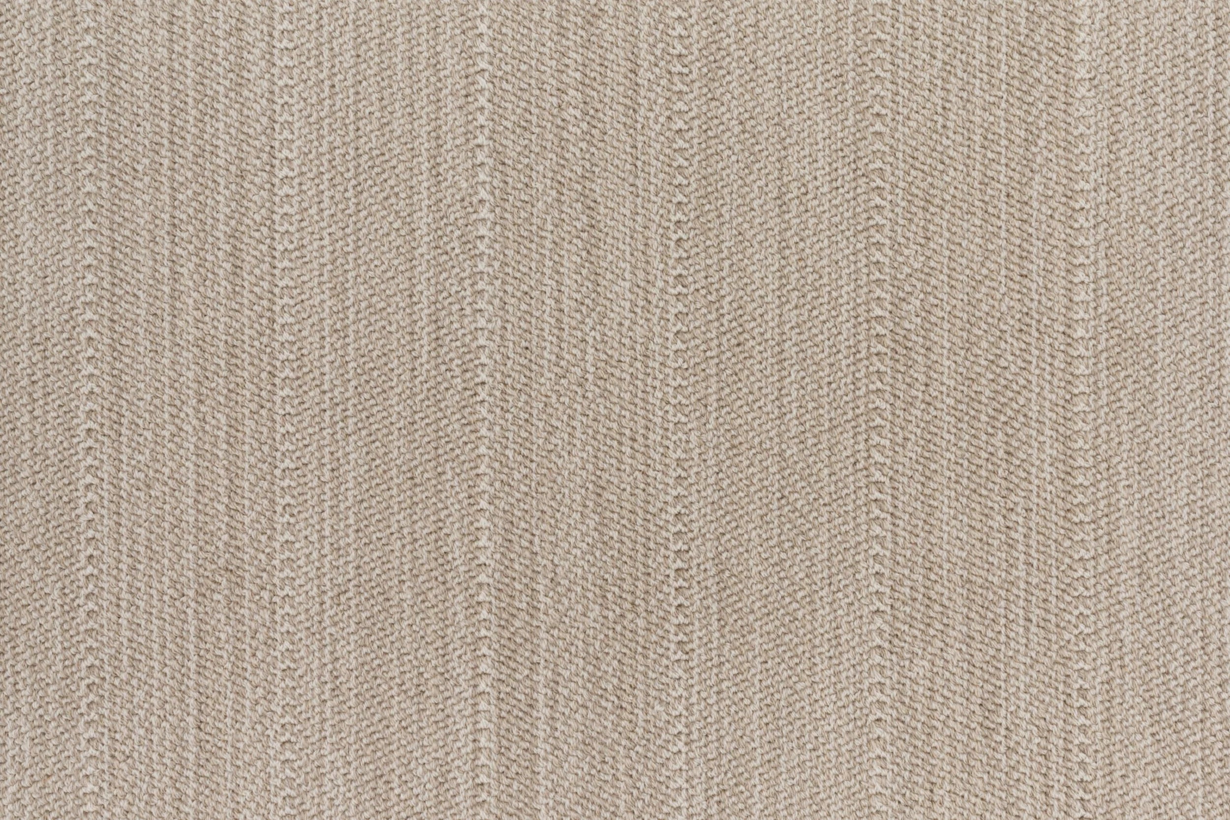 Close up of a broadloom carpet with a herringbone stripe in taupe.