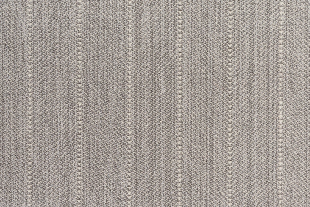 Close up of a broadloom carpet with a herringbone stripe in grey.