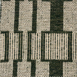 Handwoven rug detail in a dimensional design in green and beige