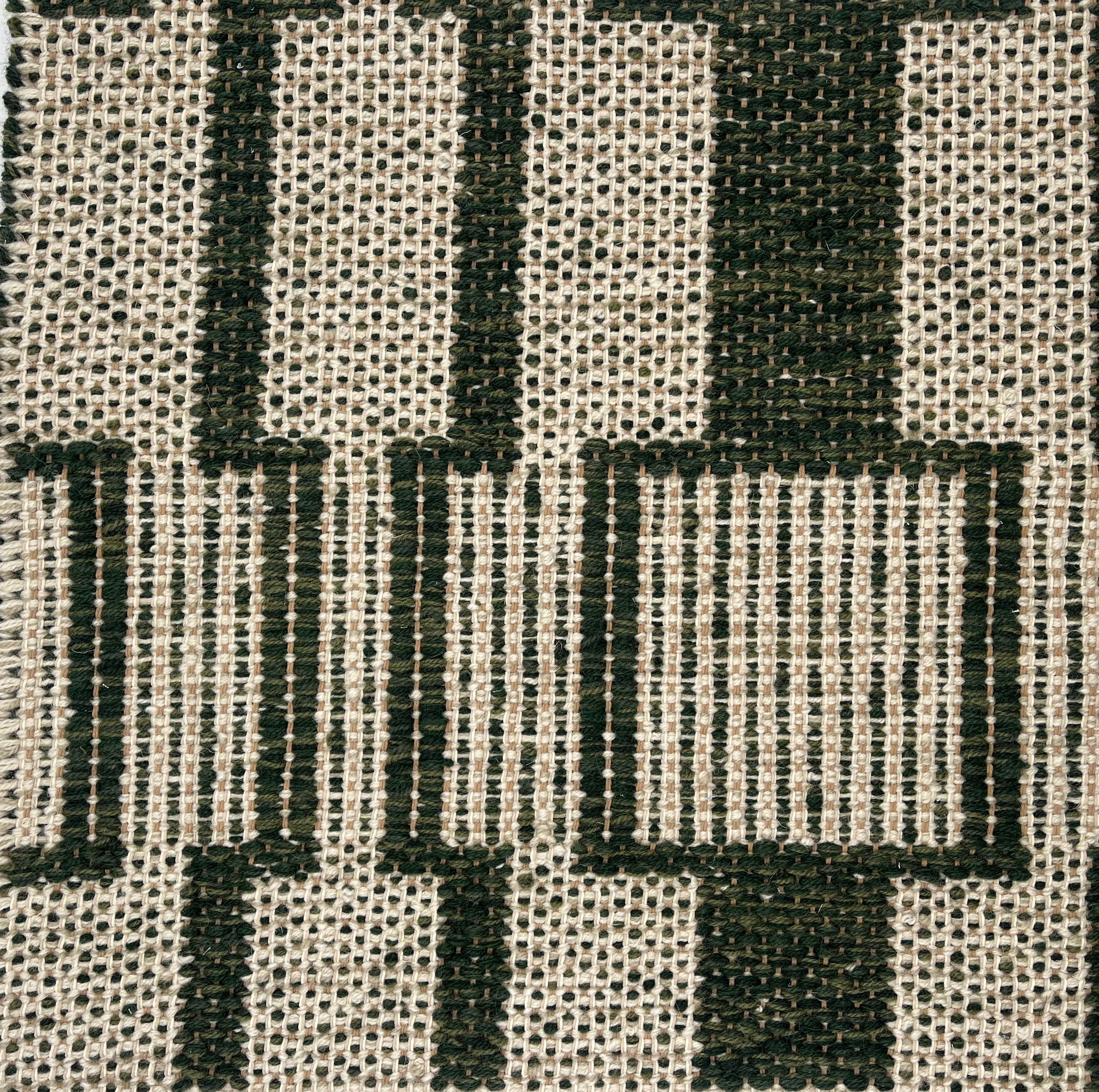 Handwoven rug detail in a dimensional design in green and beige