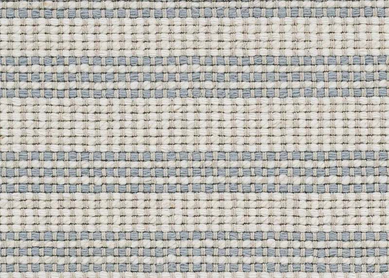 Broadloom carpet with stripes in cream and blue.