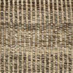 Handwoven rug detail in a textural design in beige, tan, and brown