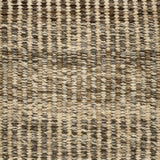 Handwoven rug detail in a textural design in beige, tan, and brown