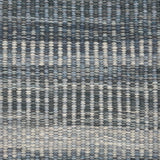 Handwoven rug detail in a textural stripe design in slate and grey