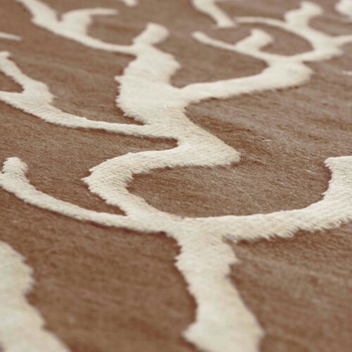 Close-up of a textured brown and beige rug with wavy pattern