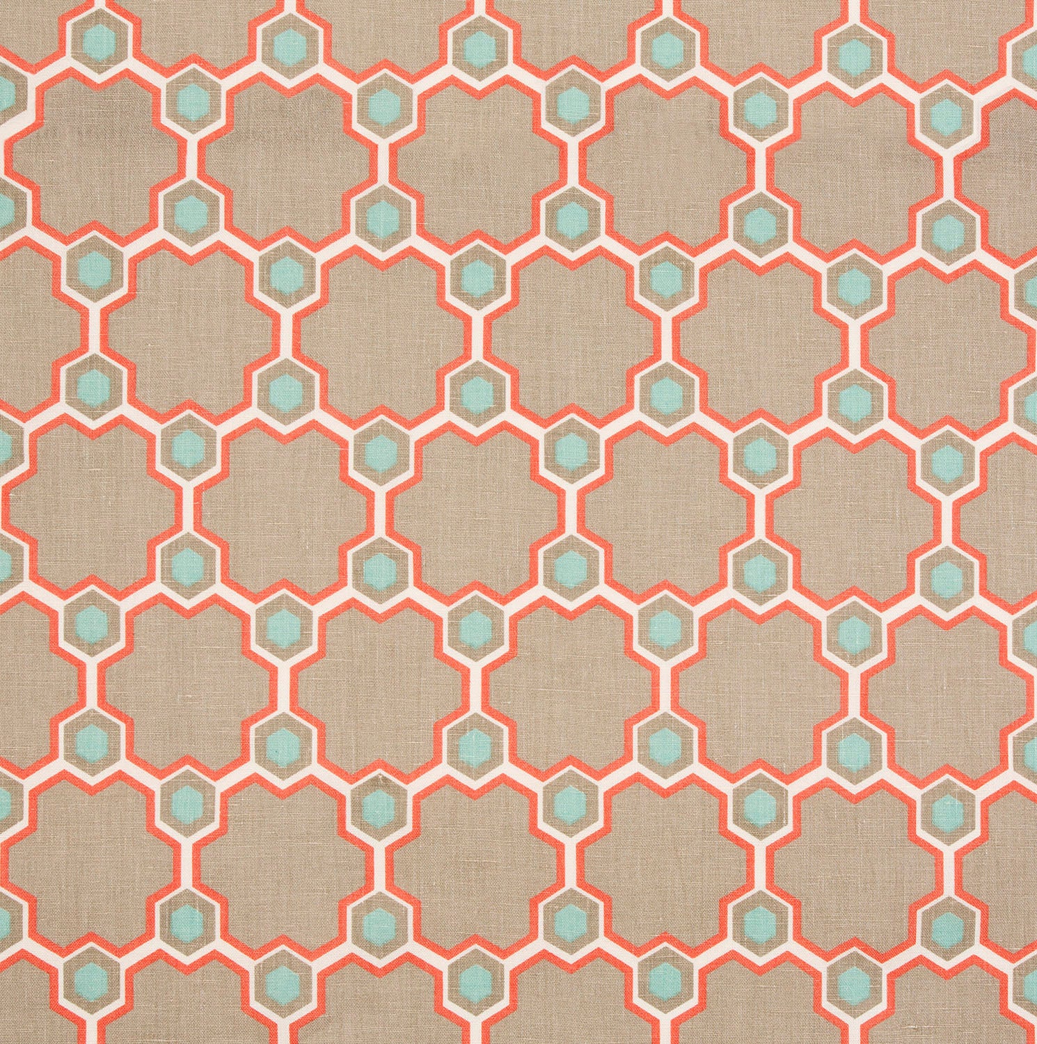 Detail of fabric in a geometric honeycomb pattern in shades of tan, white, blue and coral.