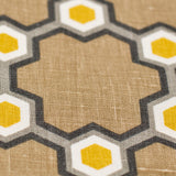 Fabric yardage in a geometric honeycomb pattern in shades of brown, yellow and gray.