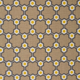 Detail of fabric in a geometric honeycomb pattern in shades of brown, yellow and gray.