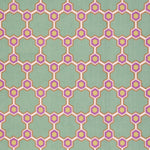 Detail of fabric in a geometric honeycomb pattern in shades of green, purple, white and orange.