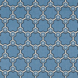 Detail of fabric in a geometric honeycomb pattern in shades of blue, cream and charcoal.