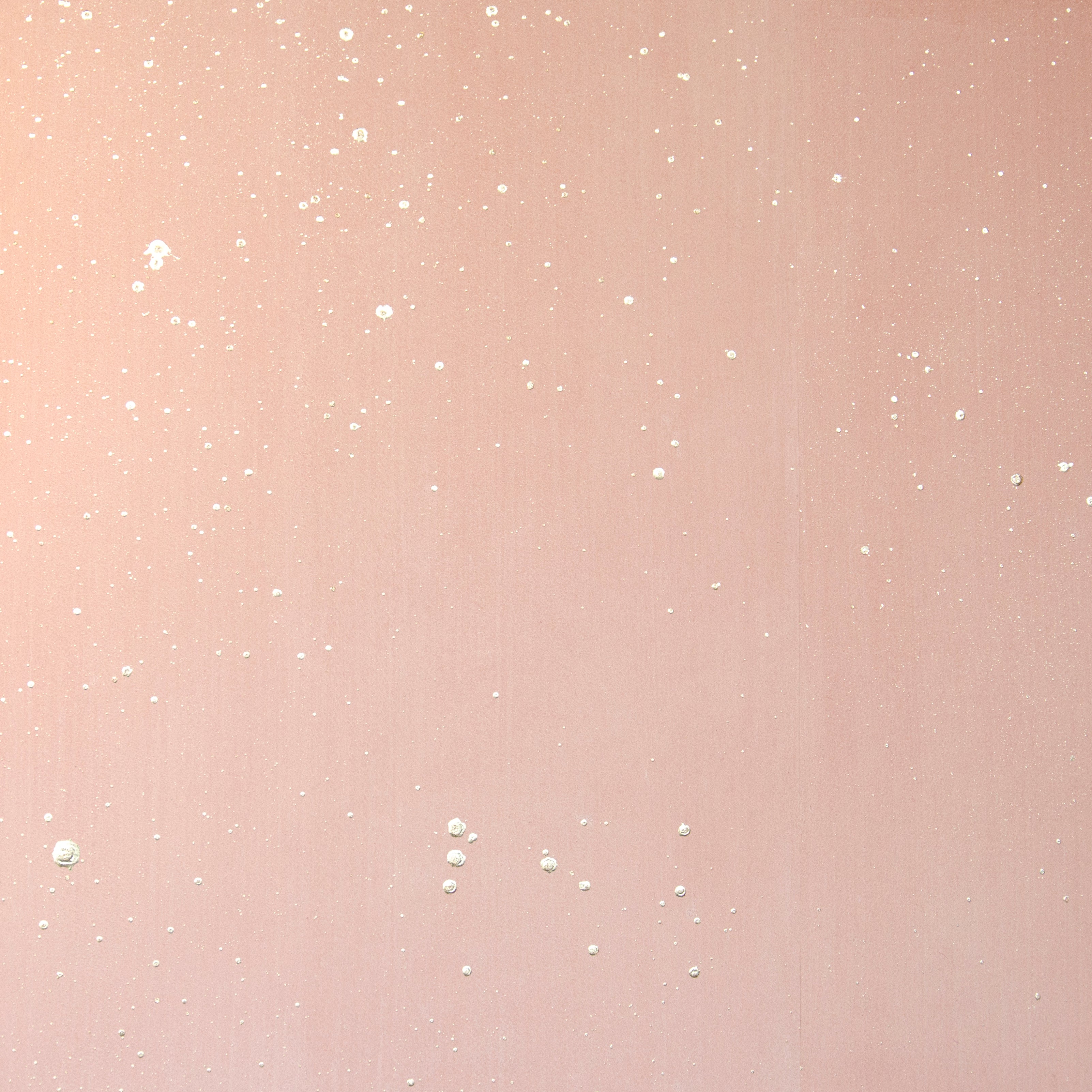 Detail of a wallpaper in a random splattered pattern in metallic cream on a pink field.