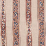 Detail of fabric in a striped paisley print in blue and brown on a cream field.