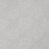 Detail of a printed linen fabric in a repeating camellia pattern in white on a gray field.