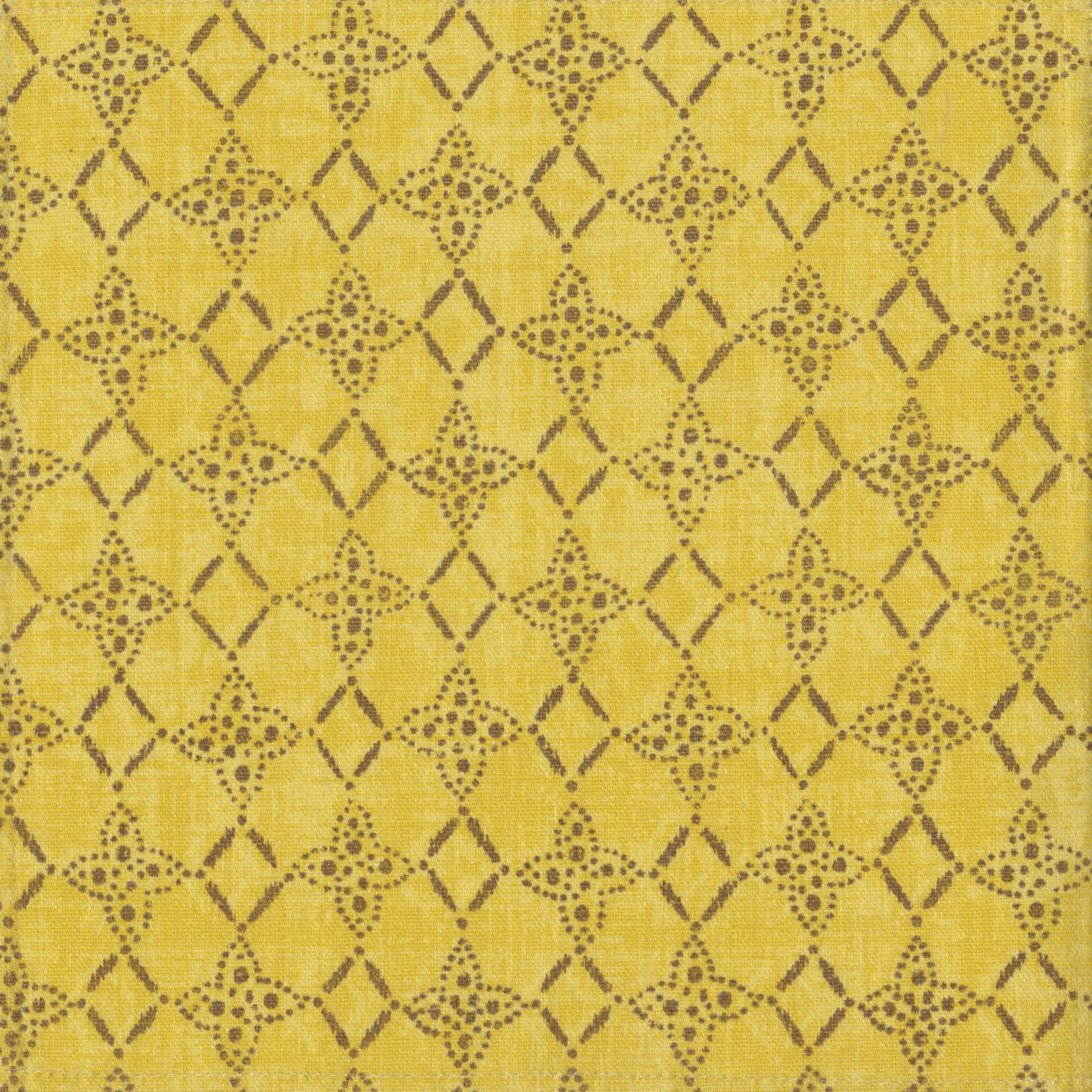 Detail of fabric in a botanical lattice print in brown on a mottled yellow field.