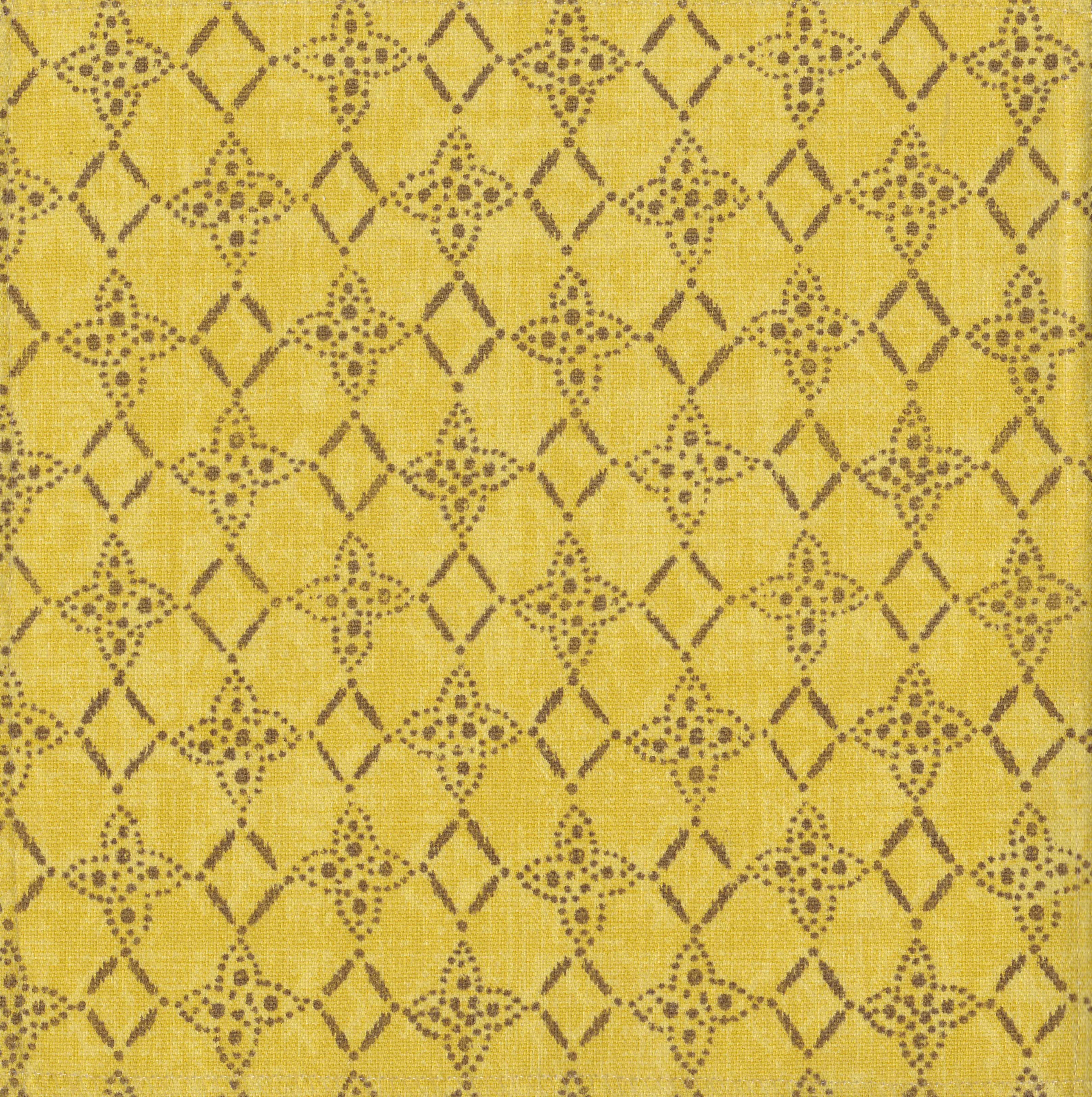 Detail of fabric in a botanical lattice print in brown on a mottled yellow field.