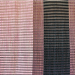 Close-up of a woven leather rug in an irregular stripe print in shades of pink, purple and black.