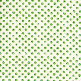 Detail of fabric in a painterly dot print in green and blue on a light yellow field.