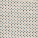 Detail of fabric in a painterly dot print in blue and brown on a cream field.